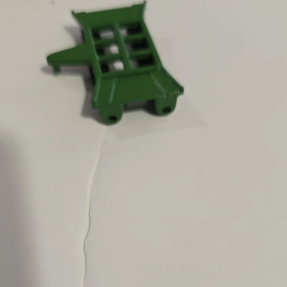 Toy John Deere combine corn head, likely an Ertl 1/64 scale model.